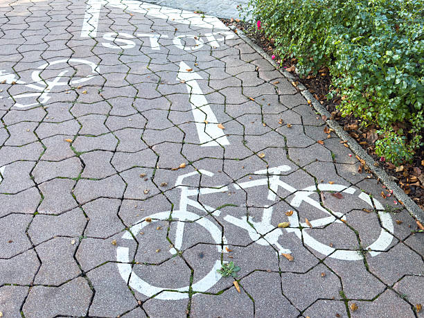 istock Bicycle lane on brick path with stop sign and foliage 2236788835