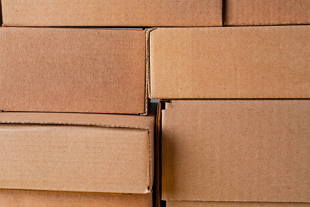 istock Cardboard boxes stacked in a pile as a background 2236790139