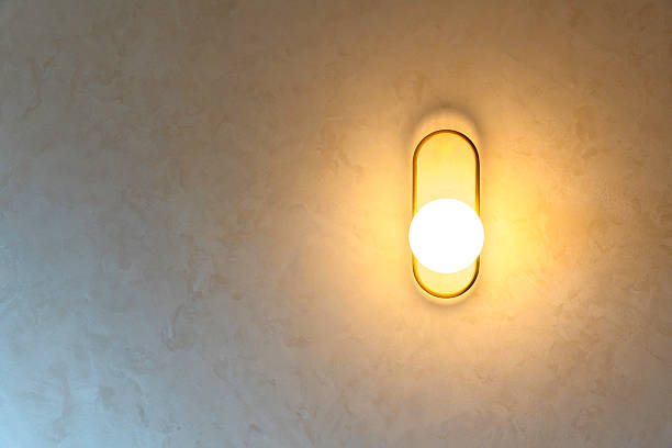 Decorative wall lamp with warm light in modern interior, creating cozy atmosphere, stylish design and contemporary home decoration.