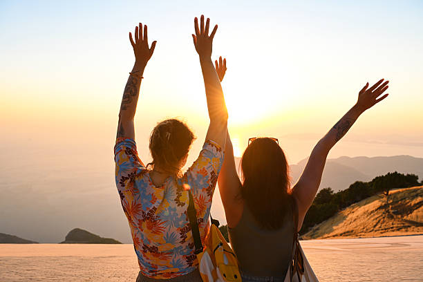 istock young women watching the sunset on a mountain top 2236794005