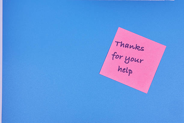 istock Thank you word on sticky note in close-up on pink background 2236797059