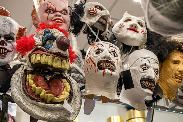 istock Collection of creepy masks displayed on a rack, featuring various horror-themed designs, showcasing vibrant colors and intricate details for Halloween 2236801886