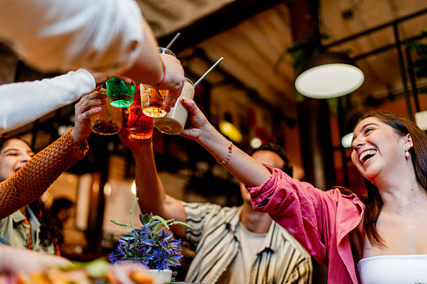 Friends toasting drinks during lunch at restaurant
