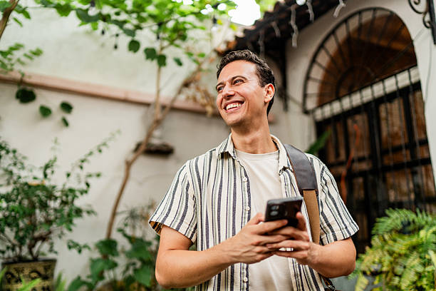 istock Young man contemplating and using mobile phone outdoors 2236808533