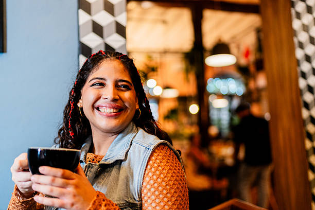 istock Young woman contemplating while drinking coffee at coffee shop 2236809077
