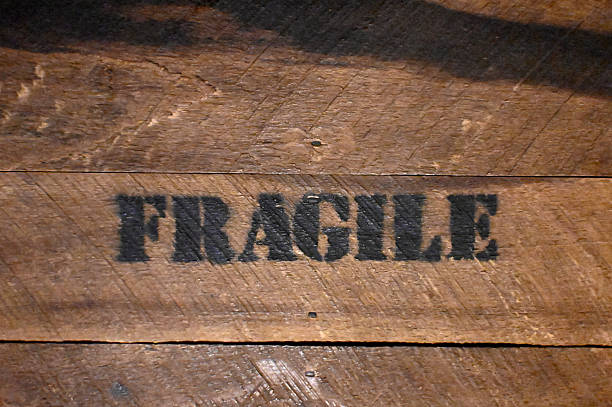 Fragile Text  Stencil on Raw Vintage Old Wood Background