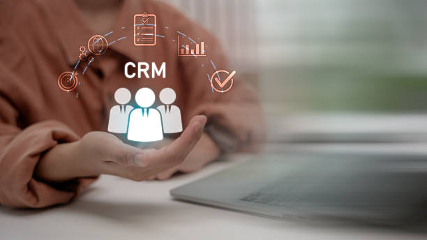 istock Hand presenting CRM icons with people, chart, target, checklist, and network, symbolizing customer relationship management system in modern digital business strategy. 2236812105