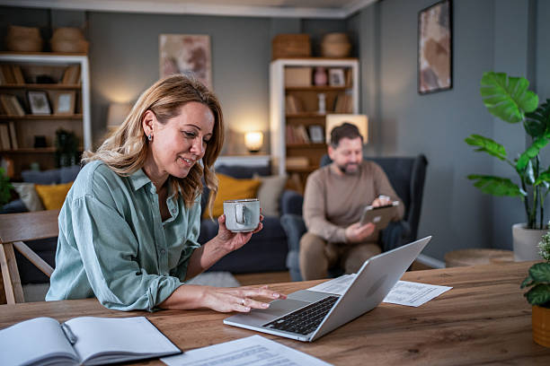istock Couple working from home remotely using laptop and tablet 2236814142