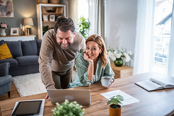 istock Married couple planning finances using laptop at home 2236814190