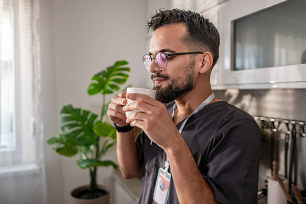 istock Healthcare worker taking coffee break at home kitchen 2236815459