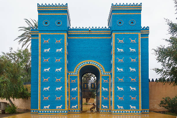 A guard sits at the Ishtar Gate in the ancient city of Babylon in Hillah, Iraq, on a cloudy day. It is a UNESCO World Heritage Site.