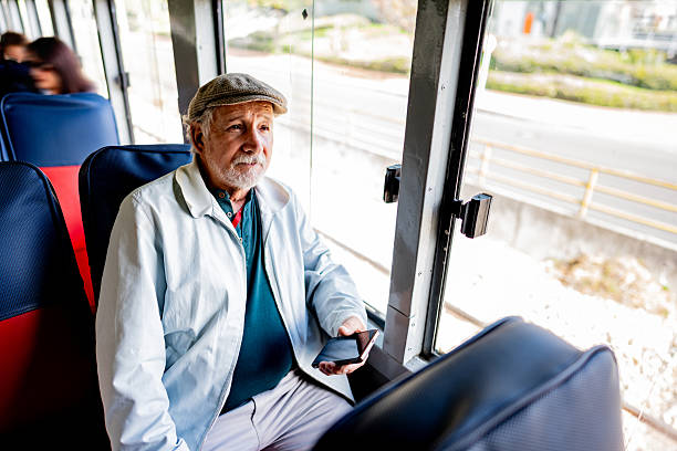 istock Senior man using mobile phone on the La Sabana tourist train 2236820513
