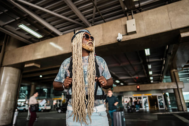 Mid adult man looking around while walking at the airport