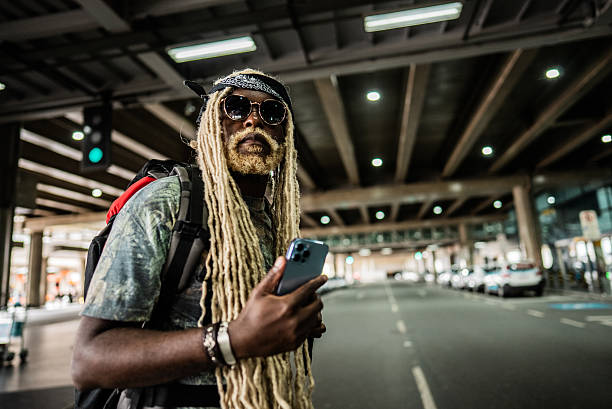 Mid adult man looking around while walking at the airport