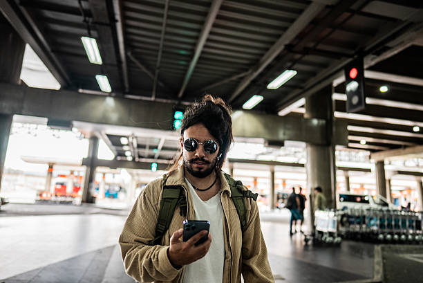 istock Mid adult man using the mobile phone while walking at the airport 2236821015