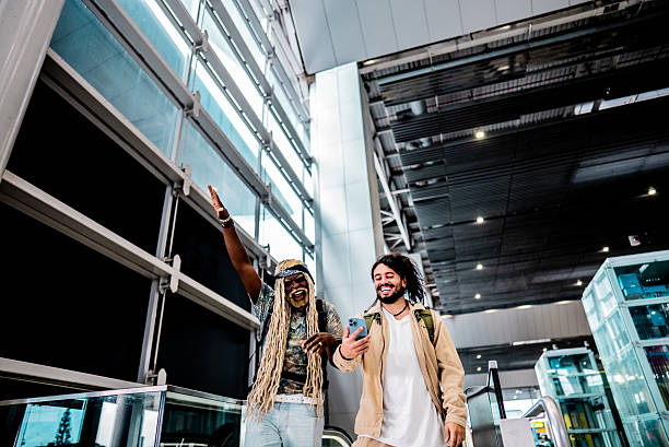 istock Friends using the mobile phone at the airport 2236821103