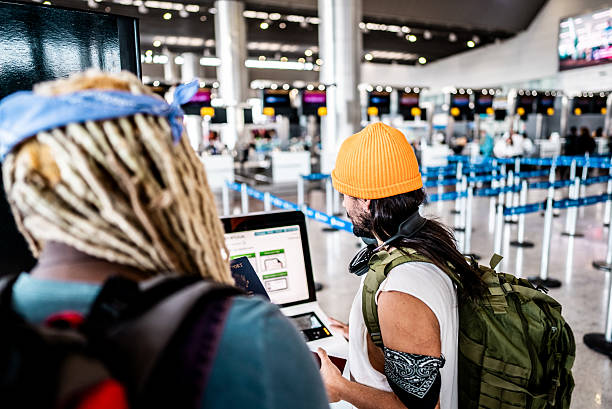 istock Friends using a self-service check-in machine at the airport 2236821112