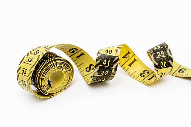 istock Yellow measuring tape twisted on a white background 2236822753