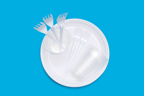 istock Disposable white plastic tableware in the form of plates, glasses and forks on a blue background 2236822784