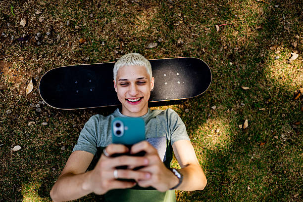 istock Young man using the mobile phone at the park 2236823205