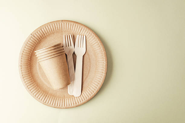istock Eco friendly tableware arrangement on green background with paper cups and forks 2236823747