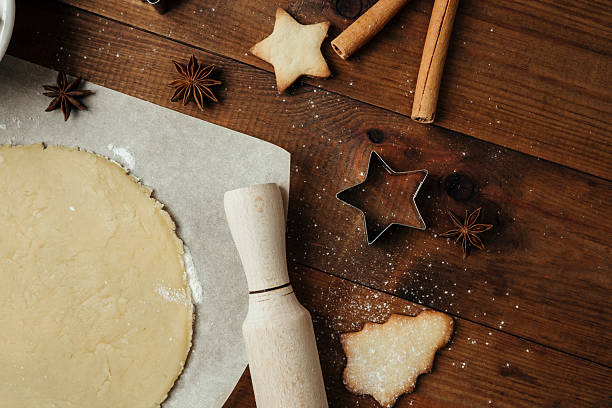 istock Festive cookie dough and baking setup on wooden table for christmas culinary and rustic food concept 2236823770