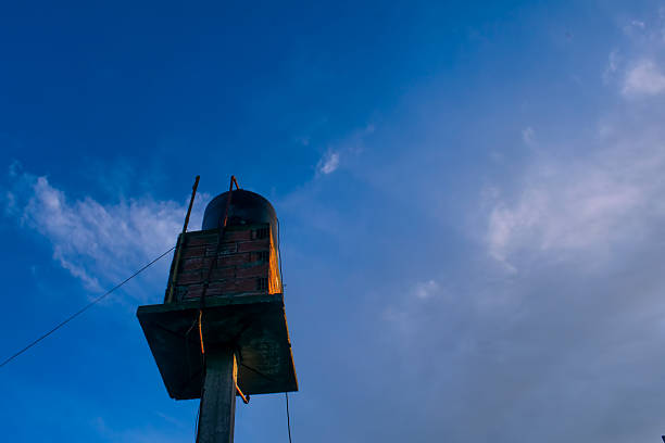 Cloudy sky backdrop with water tower.