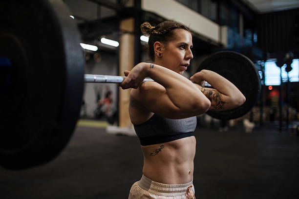 istock Woman lifting barbell 2236827738