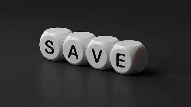 istock Symbol for saving or spending money. Dice form the word  save  while the word  spend  is visible in the reflection.3D rendering on black background. 2236829580