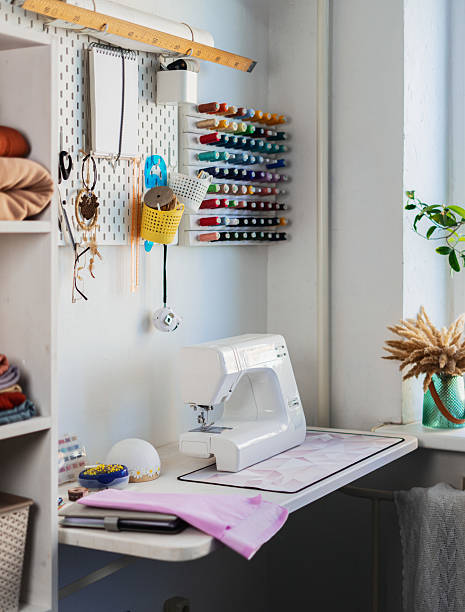 istock Cozy sewing workshop filled with professional equipment, fabrics, and creative tools. Well-organized space provides perfect environment for tailoring and custom clothing production. 2236829679