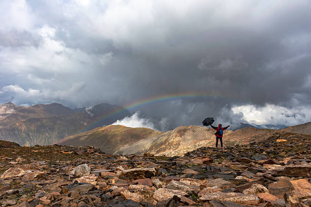 istock Adventurer Witnessing Rainbow Over Mountains 2236832373