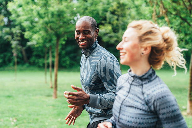 istock Cardio training outdoors. Happy athletic couple having fun while running together in nature. 2236834817