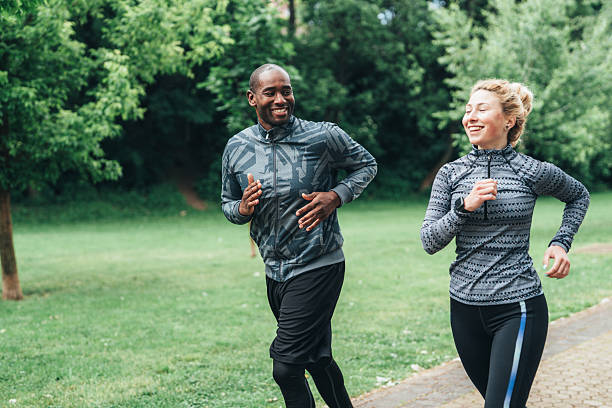 istock Cardio training outdoors. Happy athletic couple having fun while running together in nature. 2236834818