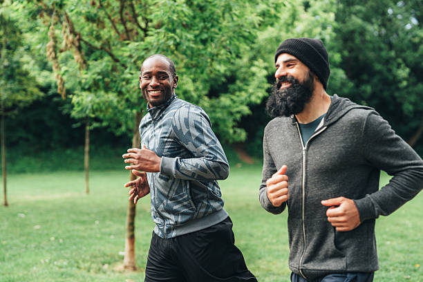 istock Cardio training outdoors. Happy athletes having fun while running together in nature. 2236834833