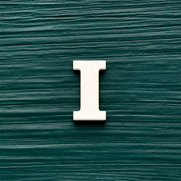 istock Alphabet letter I, white piece on a dark green rustic background 2236836170