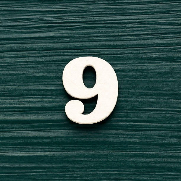istock Number nine - White wooden number on a rustic dark green background 2236836181