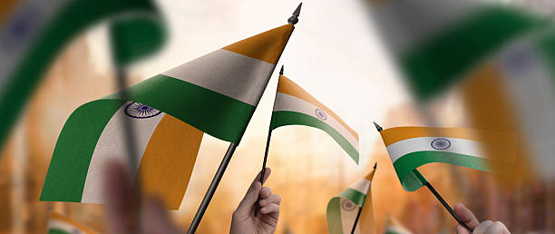 istock India flags in their hands on a blurred urban background 2236839705