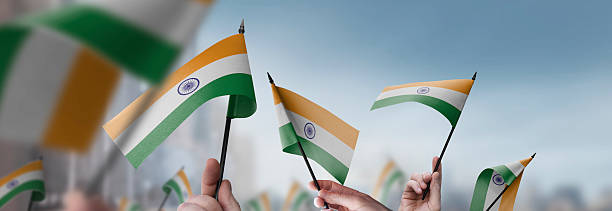 istock India flags in their hands on a blurred urban background 2236839727