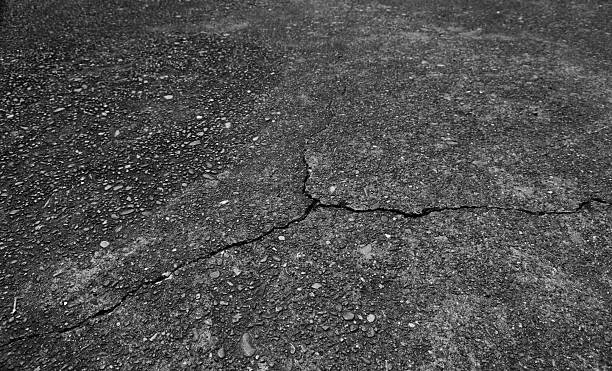 istock Cracks in the asphalt road. 2236840123