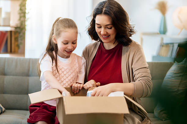 istock Mother and daughter are unpacking cardboard 2236840241