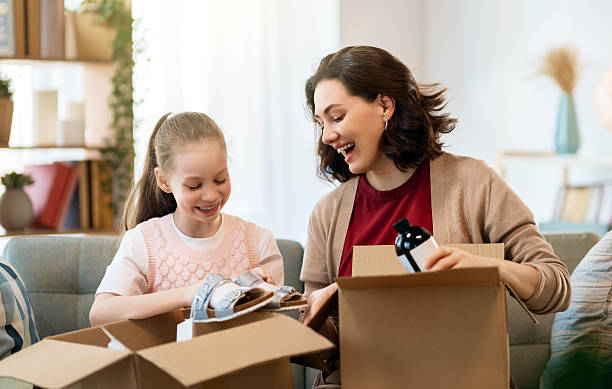 istock Mother and daughter are unpacking cardboard 2236840242