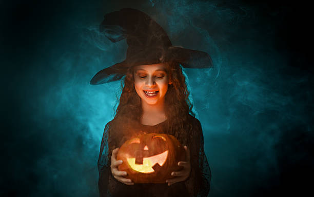 istock girl with Halloween pumpkin 2236841469