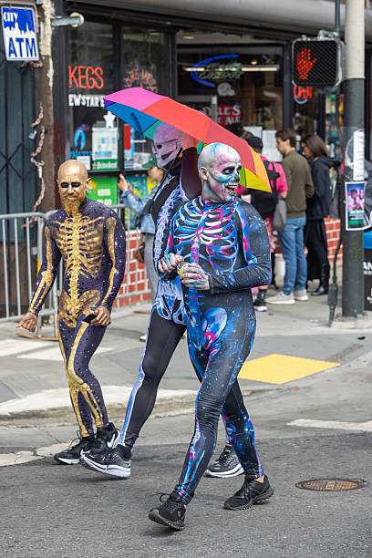 San Francisco, CA, USA - May 14, 2022: This 12K race is one of the largest and oldest running events in the world. It attracts more than 50,000 runners and 100,000 spectators every year. This race includes both serious runners and those out for a fun Sunday run. Many wear fun and funky costumes to show their spirt. Three peoples with halloween costume.