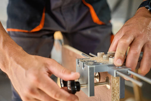 istock Carpenter using drilling jig tool to assemble wooden furniture 2236842407