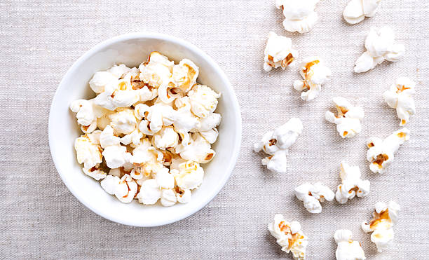 istock Popcorn, popped corn in a white bowl on linen 2236844168