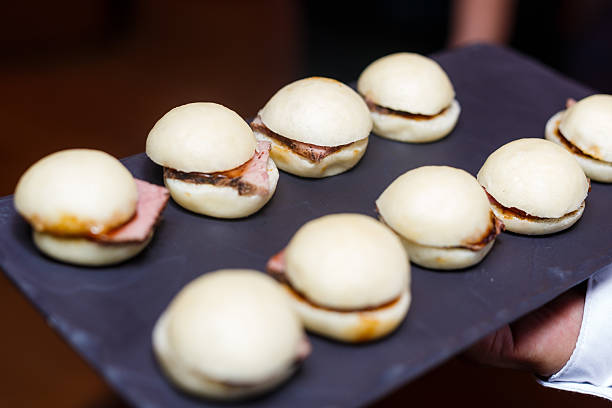 istock Server Presenting a Platter of Mini Beef Sliders Pao 2236845637