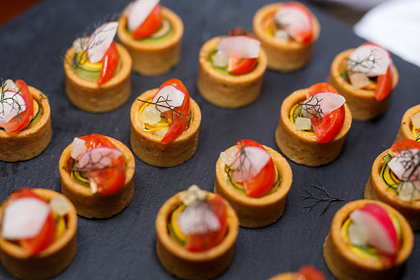 istock Gourmet Savory Tartlets with Red Tomato Slice, Radish, and Herbs 2236845663
