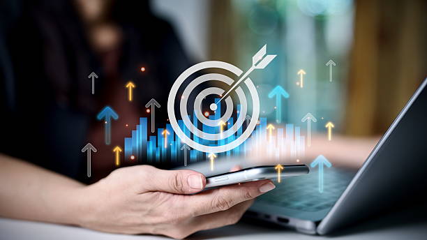 istock Businesswoman using smartphone with target and growth graph icons, symbolizing business strategy, marketing goals, data analytics, digital success, financial growth, online performance improvement. 2236846464