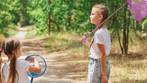 istock Curious children seeking and catching insects with a net 2236848625
