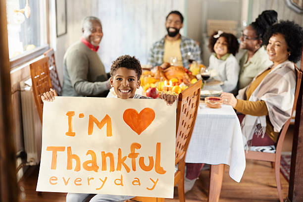 istock Happy black boy feeling grateful during Thanksgiving with his family. 2236848822